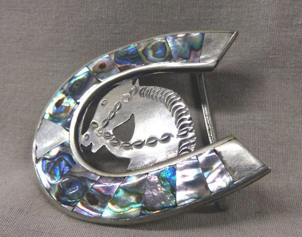 Mexican Alpaca Silver Abalone Shell Horsehead Buckle: Mexican Alpaca Silver and Abalone Shell Cowboy Buckle, measures 2'' x 2.5'', stamped Alpaca Sterling, features horseshoe with inlay abalone shell and silver horse