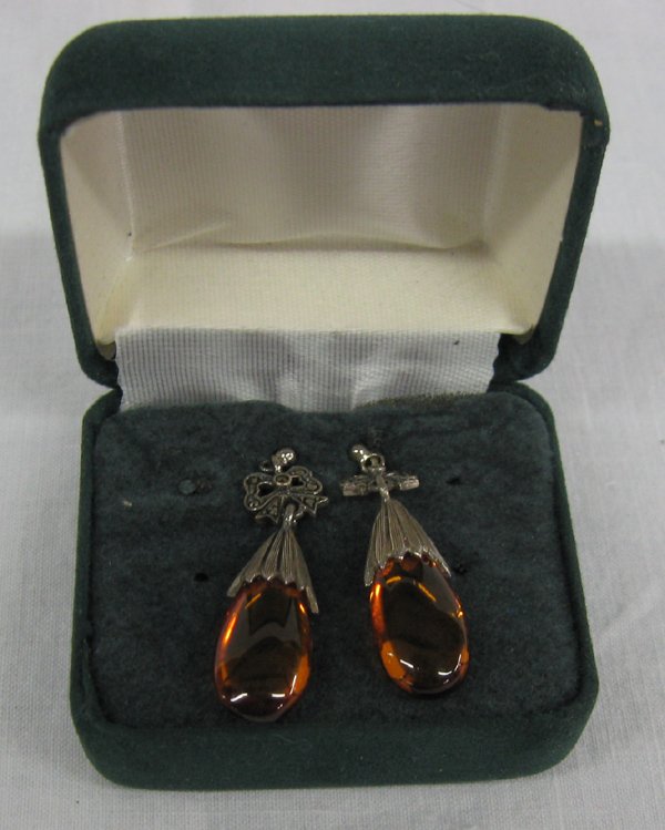 Genuine Amber & Sterling Earrings With Marcasite: Genuine Amber & Sterling Earrings With Marcasite. Amber drops with sterling silver. Small marcasite bows set in sterling, post style. Signed ''925'' and ''Thailand''. Measures 1 1/2''.