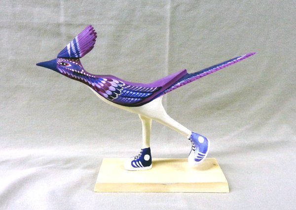 Navajo Roadrunner in Sneakers Folk Art - Yellowman: Navajo Roadrunner in Sneakers Folk Art - Matthew Yellowman, measures 7.25''H x 2.25''W x 9.5''L, beautifully painted in shades of purple on cream, mounted on wooden base, signed by artist on bottom, c