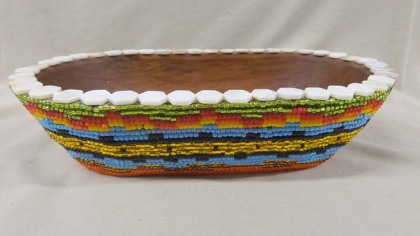 Beaded Wooden Bowl by Kills Thunder: Beaded Wooden Bowl by Kills Thunder. Measures approx. 2.75''H x 11''L x 6.5''W. Kathleen Kills Thunder was born in Seattle, Washington. Kathy has been painting and beading since she was six. She uses 
