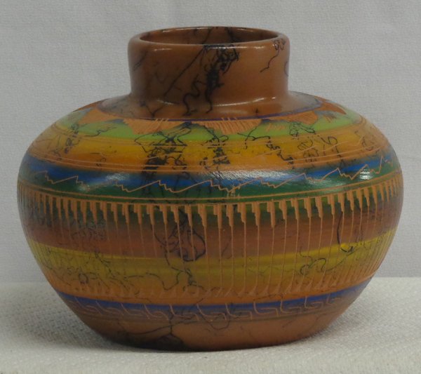 Navajo Polychrome Sgraffito Jar by Samantha Willie: Navajo Polychrome Sgraffito Horsehair Pottery Jar by Samantha Willie, measures 4.75''H x 6.5''D, beautiful warm colors on brown, stylized feather and mountain designs, sgraffito signature by artist on