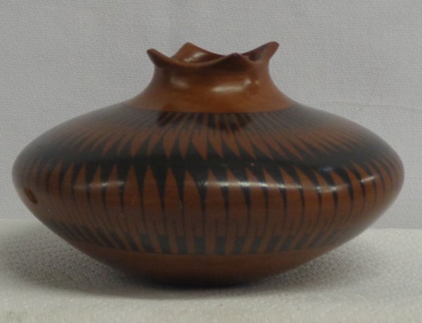 Mata Ortiz Stylized Feather Jar: Mata Ortiz Stylized Feather Jar, measures 6.5''D x 3.5''H, cutaway rim, beautiful chocolate brown with black stylized feather designs, .5'' x .25'' chip in middle of jar