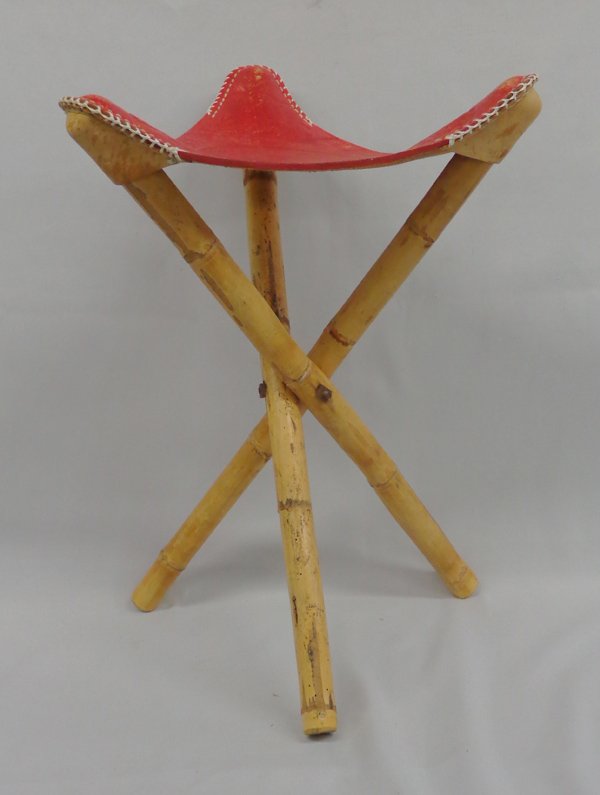 Mexican Mayan Leather Tripod Stool on Bamboo Stand: Mexican Leather Tripod Stool on Bamboo Stand, seat measures 14.25'' x 13'' x 13.75'' and bamboo tripod collapsed measures 23''L, seat is heavily tooled red leather with a Mayan pyramid, the Mayan Cale