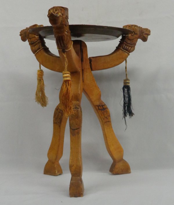1978 Tangiers Moroccan Camel Brass Table: 1978 Tangiers Morocco Camel Table, brass and copper tray measures 13.5''D, flower motif designs on tray, the table stand is carved wooden camels and is tripod style, 3 decorative tassels hanging on ne