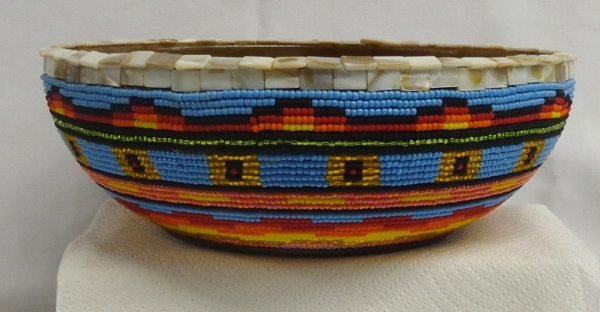 Large Beaded Bowl by Kills Thunder: Large Beaded Bowl by Kills Thunder. Noted artist, Kills Thunder, while noted for her paintings she is also a skilled bead artist as this bowl attests. The wooden bowl measures 12'' in diameter and sta