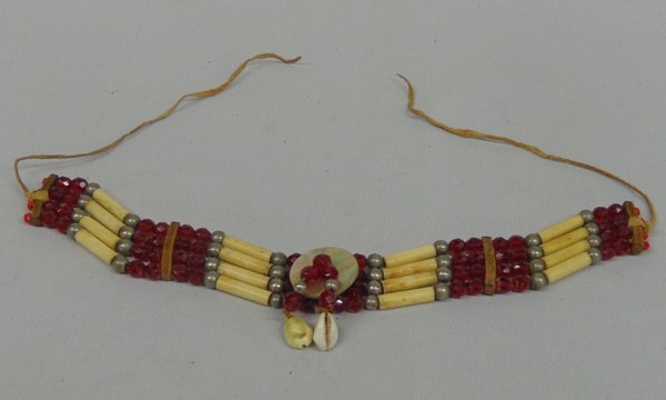 Plains Indian Choker: Plains Indian Choker. Measures 12.5''L x 1.25''W, Spacers of leather are used in this traditionally styled choker, using hare pipe, silver beads and faceted ruby plastic beads. Abalone shell disc is u