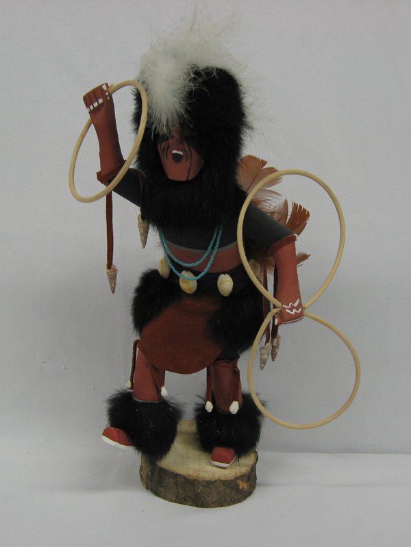 Navajo Hoop Dancer Kachina by Ferdinand Belone: Navajo Hoop Dancer Kachina by Ferdinand Belone, measures 15''H x 9''W x 6''Deep, hand carved, painted, and embellished with rabbit fur, feathers, seashells, and leather, one hoop is damaged, signed on