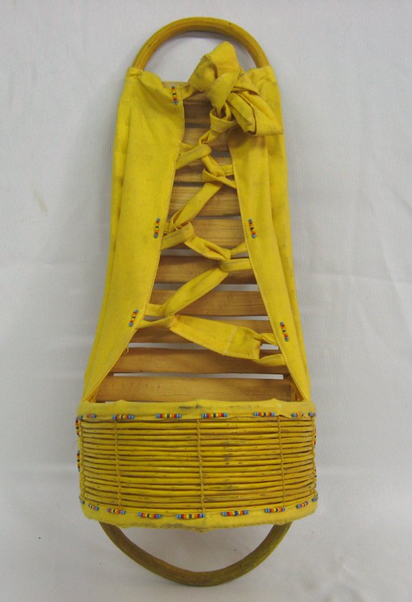 Apache Beaded Infant Cradle Board: Apache Beaded Infant Cradle Board. Nicely crafted from yucca with the cotton material dyed yellow from the root of the yucca plant. Decorated with multi-colored seed beads. Measures 21'' long x 8'' wi