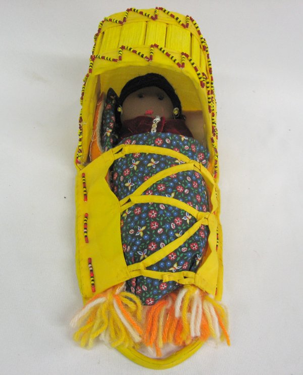 Native American Doll & Cradle Board by Lily Swift: Native American Doll & Cradle Board by Lily Swift of the San Carlos Apache Pueblo. This precious item, made the the Yucca Cactus with cloth dyed with the Yucca root, measures approx. 12''L x 6.5''W x 