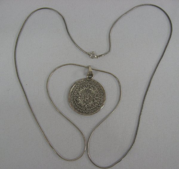 Sterling Silver Mayan Calendar Pendant Necklace: Sterling Silver Mayan Calendar Pendant Necklace, necklace has Mayan Calendar on one side and Mayan Chacmool figure on opposing side, chain measures 29.5'' end to end, pendant measures 1.25''D, 17.1g i