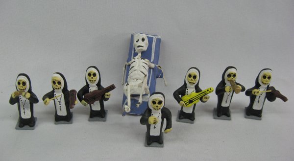 Day of the Dead Collectibles, 7 Piece Nun Band: Day of the Dead Collectibles, 7 pc Nun Band. Nun figurines, measuring 1 3/4'' and a skeleton on a coffin, measuring 2 1/2''.