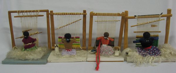 Four Navajo Weaver Dolls: Four Navajo Weaver Dolls. Traditional souvenir items depicting Navajo weavers at work, wearing traditional clothing with a papoose by her side. Two of the pieces have quantities of fleece displayed. L