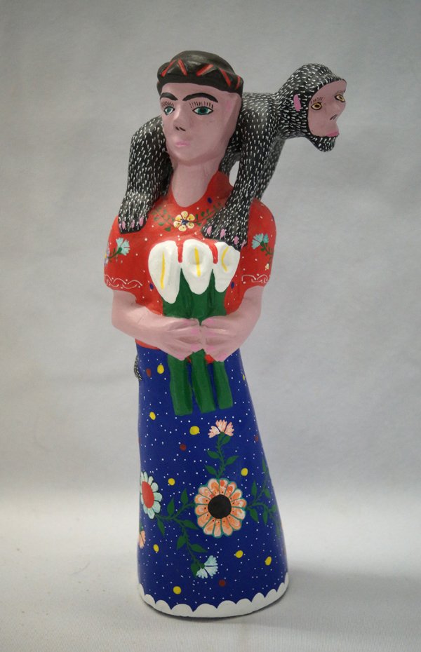 Oaxacan Alebrije Figure of Frida Kahlo by Vasquez: Oaxacan Alebrije Rare Figure of Frida Kahlo. Hand carved and painted by Inocencio Vasquez of San Martin Tilcajete, Oaxaca, Mexico and signed by the artist. With a Monkey riding her shoulders, it stand
