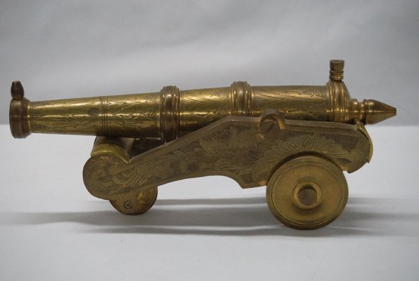 Vintage Ornatley Carved Brass Cannon: Vintage Brass Cannon, measures 9.5''L x 4''H x 3.5''W, very ornately carved, has a hallmarked of 5 dots inside, 3-wheeled, solid brass