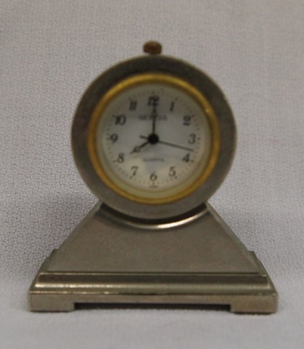 Miniature Fully Functioning Geneva Mantel Clock: Up for auction is a miniature fully functioning mantel clock just measuring a wee 2'' high x 2''L x .75'' Deep. It's a sweet little clock made of mixed metal. It shows Geneva and Quartz on the clock f