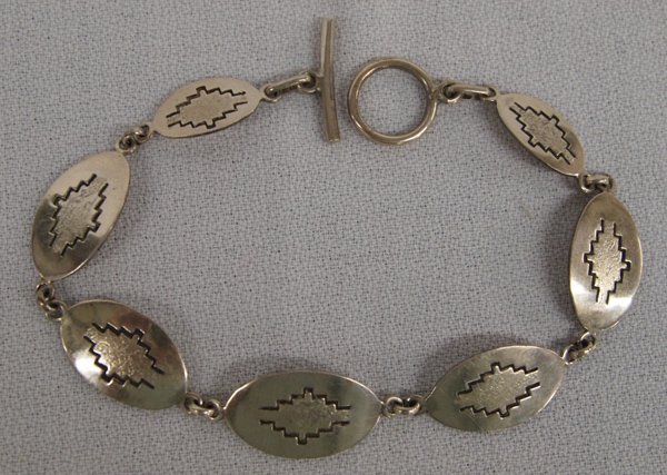 Zuni Silver Link Bracelet by Mike Simplicio d.1970: Zuni Sterling Link Bracelet by Mike Simplicio (d. 1970), measures 8'' end to end x .5''W, hallmarked MIKE and stamped sterling, stairstep cloud designs, 11.88g in total wt.