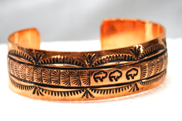 Navajo Copper Cuff Bracelet Signed by Vera Tsosie: Navajo Copper Cuff Bracelet, signed by Vera Tsosie. Traditional Navajo stamping with 3 buffalo figures in the center. Inside measurement is 6 5/8'' x 3/4''. Mark is stamped ''VT''.