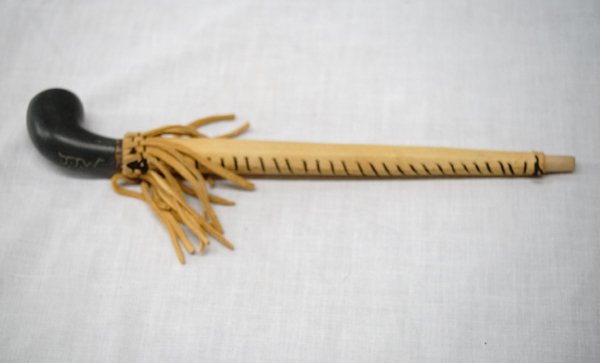 Native American Black Steatite Pipe: Native American Black Steatite Pipe with stitched fringed leather stem covering, carved bowl marked J.J.W., unique piece