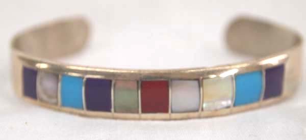 Zuni Sterling Channel Inlay Bracelet: Zuni Sterling Channel Inlay Bracelet, inside measures 6.25'' which includes opening x .25''W, inlay stones included are turquoise, mother of pearl, coral, and sugilite, 9.5g in total wt.
