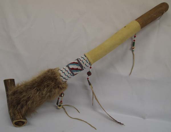 Plains Indian Beaded Horn Pipe: Plains Indian Beaded Pipe, measures 21''L, bowl is carved antler, wood stem is leather wrapped and embellished with rabbit fur and beadwork, 3 leather dangles embellished with beads, silver cones, and