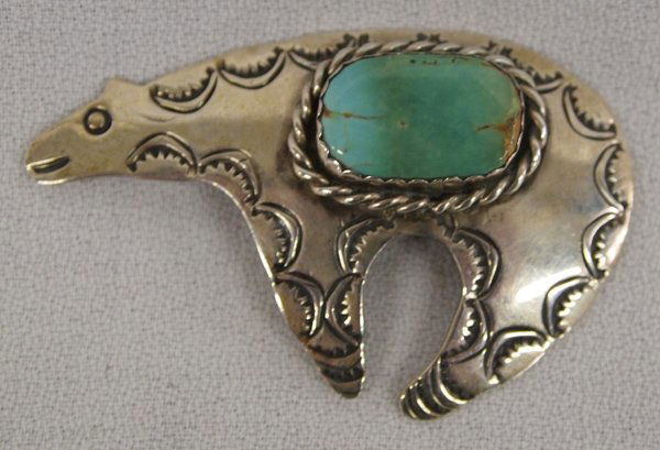 Vintage Navajo Silver Pin by Silversmith Cleveland: Vintage Navajo Sterling Silver Pin by Silversmith Albert & Janette Cleveland. This bear pin is set with a large green/blue turquoise cabachon. Hallmarked ''AJC-Sterling- this piece measures approx. 2.