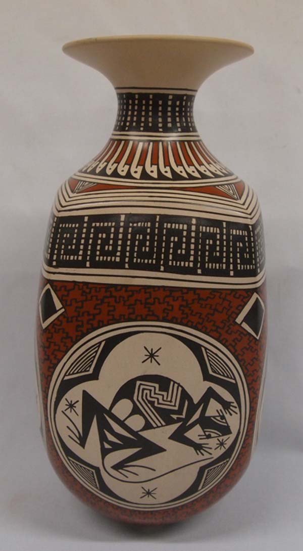 Mata Ortiz Polychrome Jar by Nancy Martinez: Mata Ortiz Polychrome Jar by Nancy Martinez. Unusual piece of collectible pottery where the artist has used animal cartouches on each side. They include 2 lizards, a quail and a frog. Exceptional glaz