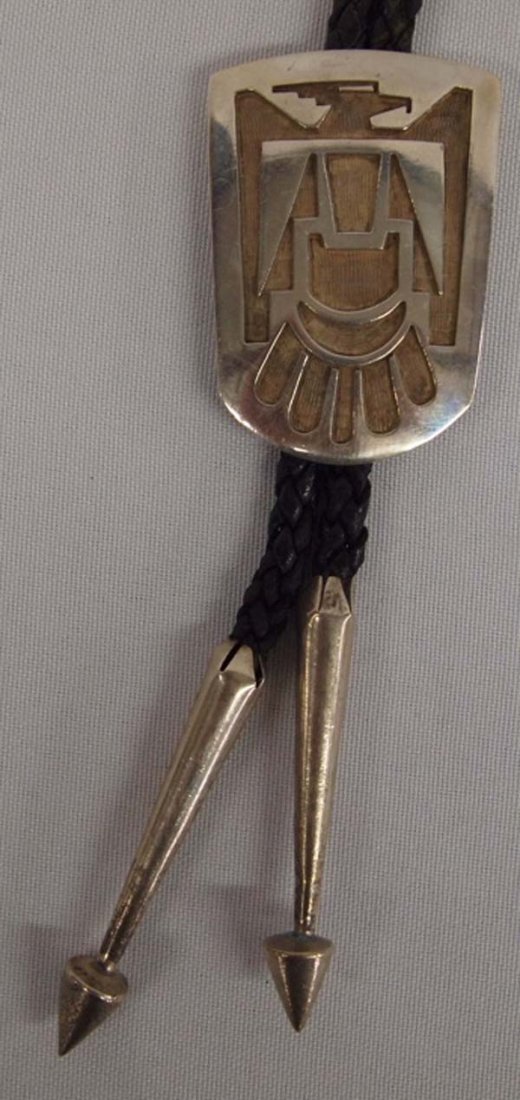 Hopi Silver Thunderbird Bolo Tie, C. Lomayestewa: Hopi Silver Thunderbird Bolo Tie by Clarence Lomayestewa, measures 2'' X 1.5'', hallmarked CL, solid sterling tips (very unusual design), 53.66g in total wt (including leather ties)