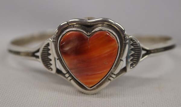 Navajo Sterling Red Shell Bracelet by June Perry: Navajo Sterling Heart Shaped Red Shell Bracelet by June Perry, hallmarked JMP and stamped sterling, inside measures 6.5'' which includes opening x 1''W, hand stamped, 1''W, 13.85g in total wt.