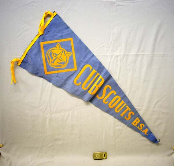 B.S.A. Cub Scout Pennant & Brass Buckle: B.S.A. Cub Scout Pennant & Brass Buckle. The pennant is approx. 30'' in length. The solid brass Buckle, with the Cub Scout Insignia, is stamped ''solid brass'' and measures approx.2.5'' x 1.5''.