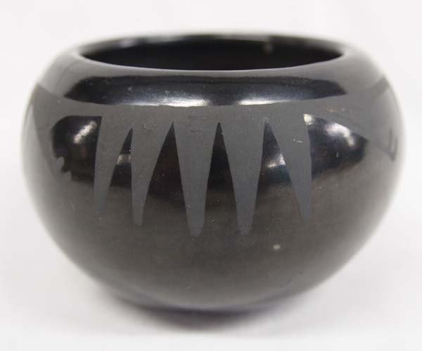 San Ildefonso Black-on-Black Pot by Pauline: San Ildefonso Black-on-Black Pot by Pauline. Burnished black-on-black pot signed ''Pauline''. Measures 2.5'' x 4''.