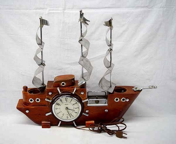 1940 Carved Wooden Schooner Clock Lamp: 1940 Carved Wooden Schooner Clock Lamp, measures 16''H x 19''W. Good condition for age, however, clock does not run. Lamp bulbs do light up.