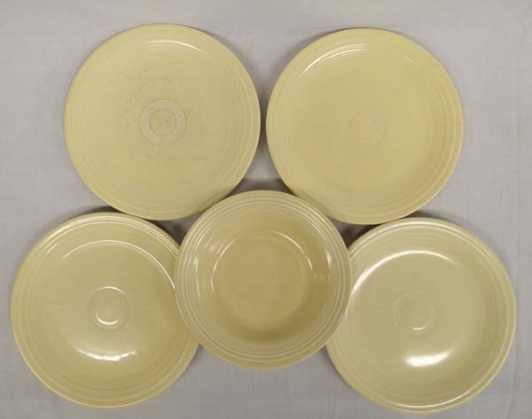 4 Vintage Fiestaware Plates and 1 Bowl: 4 Vintage 1939-1956 Homer Laughlin Fiestaware Light Yellow Plates and 1 Bowl, plates measure 9.5''D x .75''H and bowl measures 8.25''D x 1.5''H, bowl has chip in rim, all plates and bowl are marked Ge