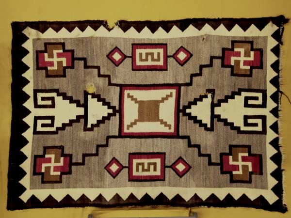 1920 Large Navajo Storm Pattern Whirling Log Rug: 1920 Large Navajo Storm Pattern Whirling Log Textile Rug, has 3 holes and selvage damage as shown in picture, measures 78.5''L x 54.5''W