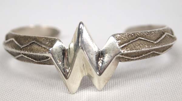 Navajo Sterling Sand Cast Tufa Bracelet: Native American Navajo Sterling Sand Cast Tufa Bracelet, inside measures 5.75'' which includes opening x 1''L, 24.66g in total wt.