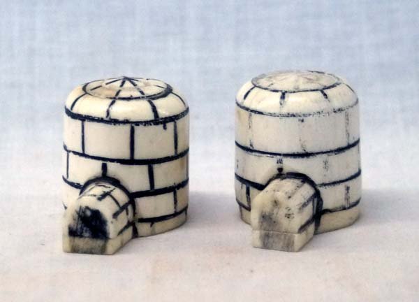 Northwest Coast Inuit Ivory Salt & Pepper Shakers: Northwest Coast Inuit Ivory Hand Carved Igloo Salt & Pepper Shakers. These pieces measures approx. 1.25''H x 1.5''W and are hand painted as well as hand carved. They weigh 60g and still have their bot