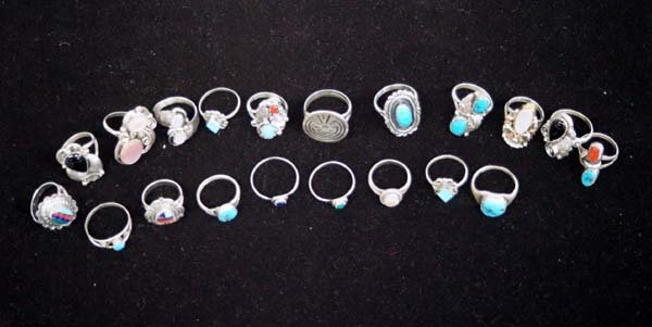 20 Native American Navajo Sterling Silver Rings: 20 Native American Navajo Sterling Silver Rings of various sizes and a variety of stones. We have Pink & White Mother of Pearl, Turquoise, Coral, and Jet. We have a man in the maze, several inlay piec