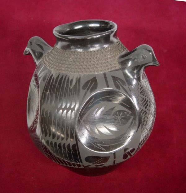 Mata Ortiz Black on Black Jar with Bird Handles: Mata Ortiz Black on Black Jar with Bird Handles. Signed on the bottom by Artist Jose Gonzalez this piece with its intricate eye dazzler design and carved raised design around its edge measures approx.