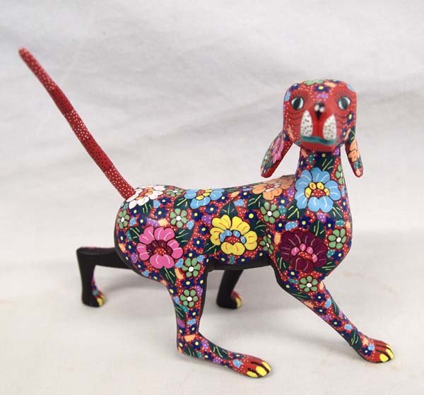 Mexican Oaxacan Alebrije' Dog by Candido J. Ojeda: Mexican Oaxacan Alebrije' Dog by Candido Jimenez Ojeda from San Martin Tilcajete Oaxaca, measures 7''L x 2''W x 5''H, vibrantly painted flowers adorn this sweet little pup, signed on bottom by artist