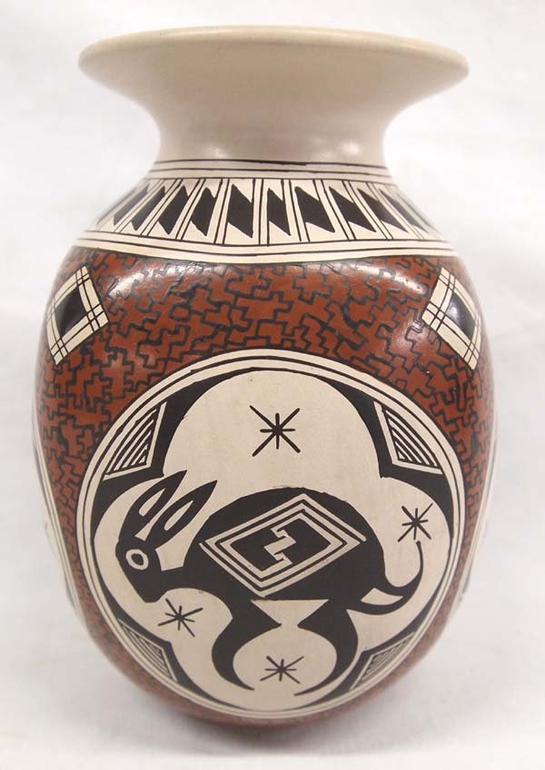 Mata Ortiz Polychrome Jar by Nancy H. Martinez: Mata Ortiz Polychrome Eye Dazzler Jar by Nancy H. Martinez, measures 6''H x 4''D, Jigsaw Designs, stylized feather designs around neck of jar, 4 animal quadrants featuring Bird, Lizards, Rabbit, and a