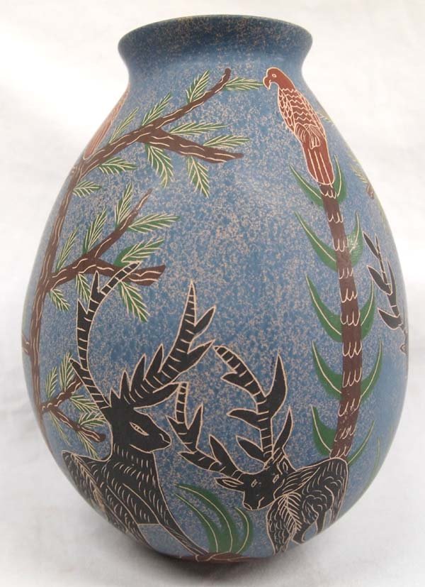 Mata Ortiz Polychrome Sgraffito Jar by Jose Villa: Mata Ortiz Polychrome Sgraffito Jar by Jose Villa, signed on bottom by artist, beautiful colors, deer and parrot scene, lovely blue and peach background, measures 8.5''H x 6.75''D