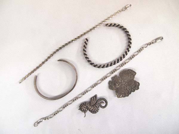 Collection of Sterling Silver Jewelry, 48.37g: Collection of Sterling Silver Jewelry, largest measures 8'' end to end, includes 2 cuff bracelets, 2 silver chain bracelets, and 2 pins, 48.37g in total wt.