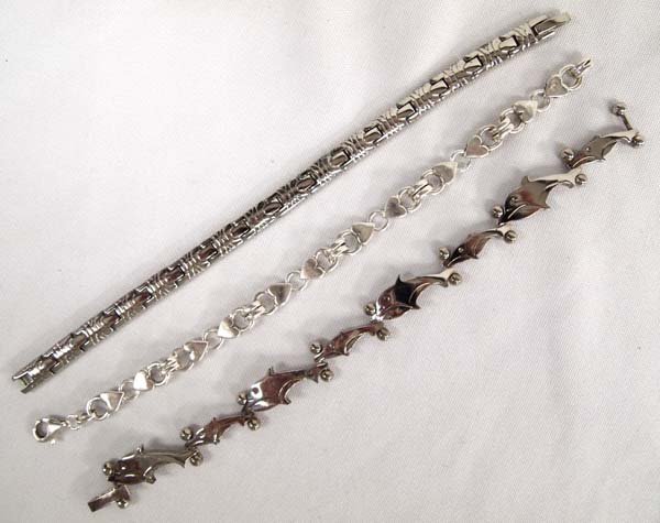 3 Sterling Silver Bracelets: 3 Sterling Silver Bracelets, all measure approx. 7.5'' end to end, includes dolphins, and hearts, nice link bracelets, 69.8g in total wt.