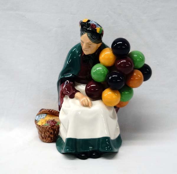 Royal Doulton Porcelain Figurine: Royal Doulton Porcelain Figurine The Old Lady Balloon Seller Figure HN1315, measures 7.5'' x 6'' x 4'', Standard printed lion crown mark with printed HN number. Designed by Leslie Harradine.