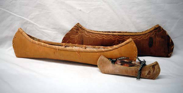 3 Native American Miniature Birchbark Canoes: 3 Native American Miniature Birchbark Canoes, longest measures 17.5''L x 4''W x 3.5''Deep, the medium sized canoe has damage to one end