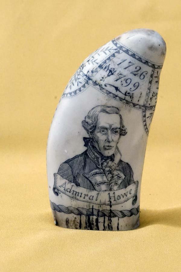 Simulated Whale Tooth Scrimshaw Carving: Simulated Whale Tooth Scrimshaw Carving, measures 5''L x 3''W x 1.5''Deep, features The Brunswick Whaling Ship on one side and Admiral Howe on the other