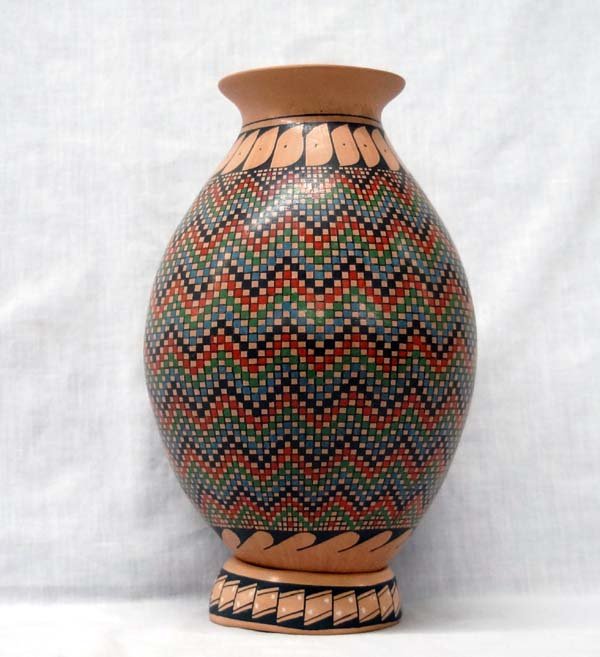 Mata Ortiz Polychrome Eye Dazzler Jar by Y. Gaona: Mexican Mata Ortiz Polychrome Eye Dazzler Jar by Yoli Gaona, measures 11''H x 7''D, signed by artist, stylized feather designs around neck of jar, comes with matching pottery ring