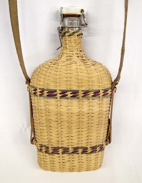 Vintage German Hiking Flask: Vintage German Hiking Flask, tri-colored basket over glass bottle, ceramic stopper, measures 11''H x 6''W, has strap for over the shoulder carrying