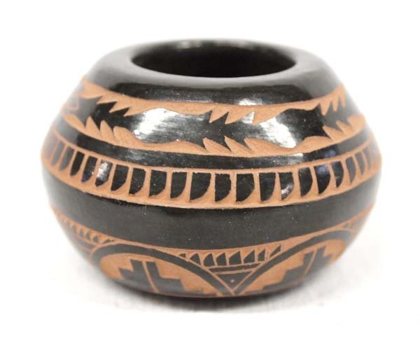 San Juan Pueblo Carved Miniature Seed Jar by Tapia: From the Whittredge Estate, we have a Native American San Juan Pueblo Carved Miniature Seed Jar by Tom & Sue Tapia, measures 1.5''H x 2.5''D, beautifully carved with intricate designs, signed by artis