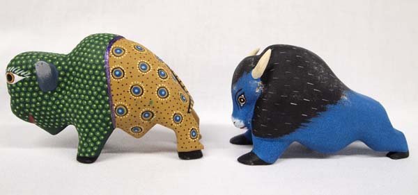 Pair of Mexican Oaxacan Alebrije Buffaloes, Signed: Pair of Mexican Oaxacan Alebrije Buffaloes, measure 3'' x 5'', the blue one is by Angel R. R., and the green one is by Isaac Fabian, vibrant colors