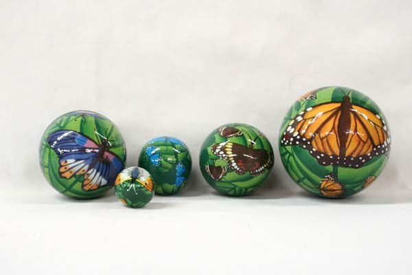 Russian Nesting Balls: Russian Nesting Balls. Lathe turned wood, Painted butterflies. 5 parts. Largest is 5'' tall.